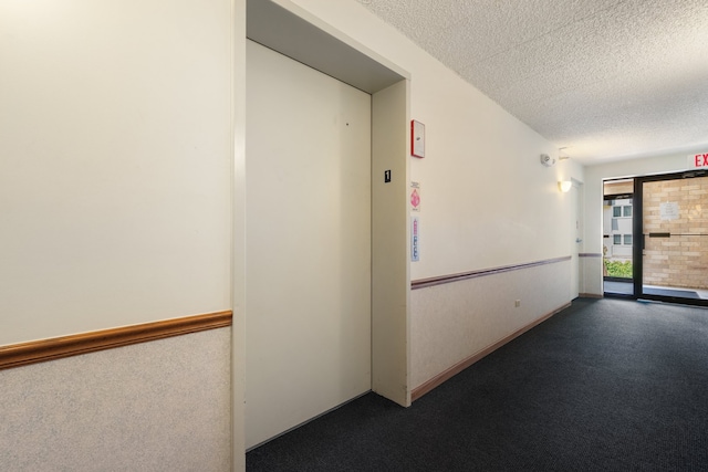 3640 186th St Unit 101, Lansing, IL 60438 - hallway with a textured ceiling, carpet, and elevator