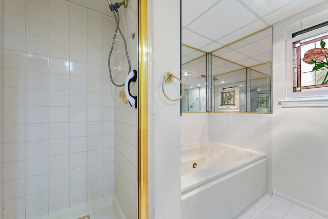 3640 186th St Unit 101, Lansing, IL 60438 - bathroom with a stall shower, tile patterned flooring, a bath, and baseboards