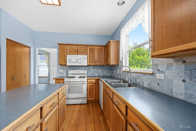 3151 Sawgrass Dr, Aurora, IL 60502 - kitchen featuring white appliances, a sink, plenty of natural light, and light wood finished floors