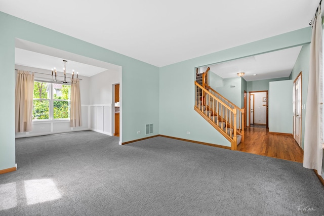 3151 Sawgrass Dr, Aurora, IL 60502 - unfurnished living room featuring carpet floors, a chandelier, stairway, and baseboards