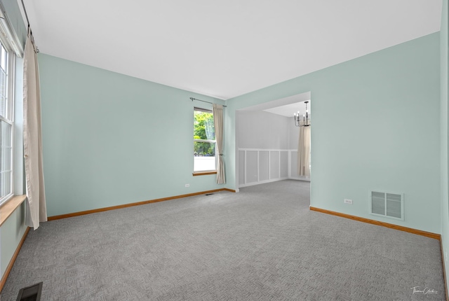 3151 Sawgrass Dr, Aurora, IL 60502 - carpeted empty room featuring a chandelier and baseboards
