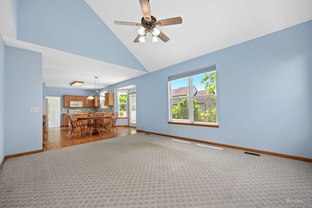 3151 Sawgrass Dr, Aurora, IL 60502 - spare room featuring baseboards, high vaulted ceiling, ceiling fan, and dark carpet