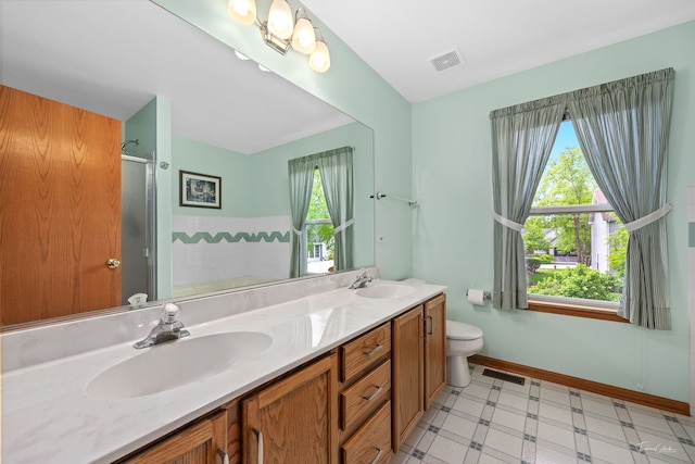 3151 Sawgrass Dr, Aurora, IL 60502 - full bathroom with healthy amount of natural light, toilet, double vanity, and a shower with door