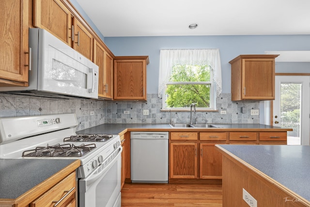3151 Sawgrass Dr, Aurora, IL 60502 - kitchen featuring white appliances, a sink, light wood-style flooring, brown cabinetry, and recessed lighting