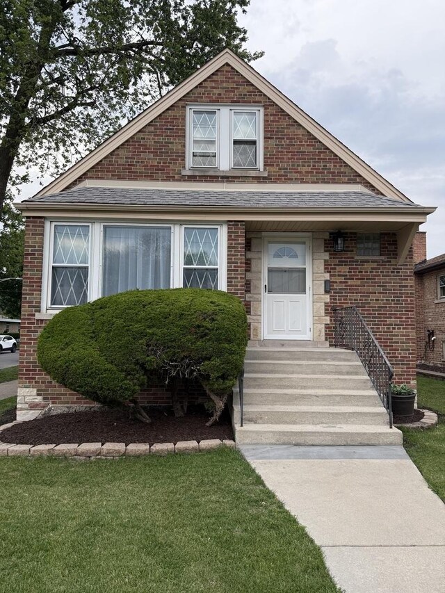 5301 S Mcvicker Ave, Chicago, IL 60638 - bungalow featuring brick siding and a front yard