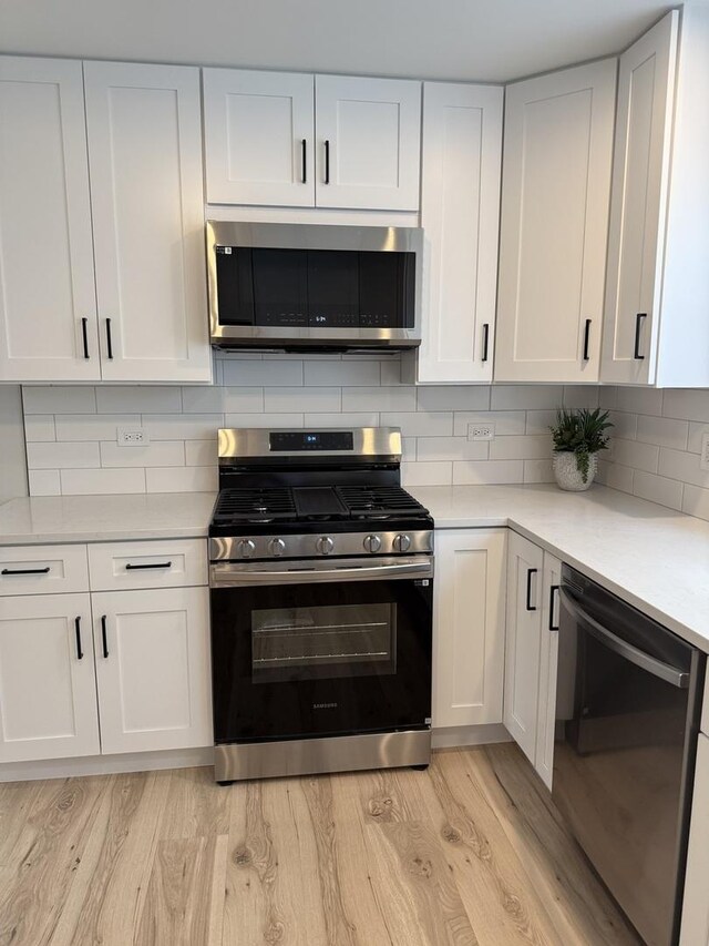 5301 S Mcvicker Ave, Chicago, IL 60638 - kitchen with stainless steel appliances, light countertops, and white cabinets