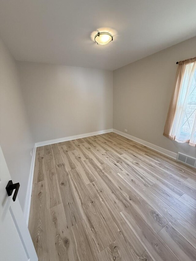 5301 S Mcvicker Ave, Chicago, IL 60638 - unfurnished room featuring wood finished floors and baseboards