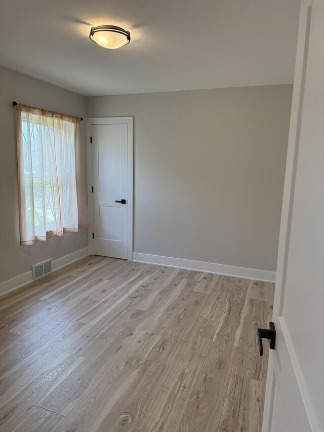 5301 S Mcvicker Ave, Chicago, IL 60638 - spare room with light wood-style floors and baseboards