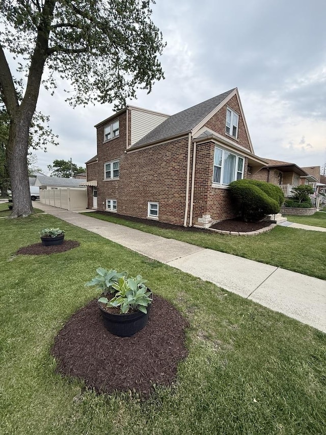 5301 S Mcvicker Ave, Chicago, IL 60638 - view of side of property with brick siding, a yard, and roof with shingles