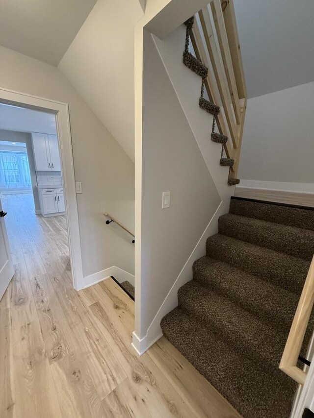 5301 S Mcvicker Ave, Chicago, IL 60638 - stairs featuring wood finished floors, lofted ceiling, and baseboards