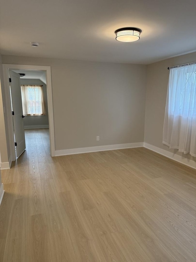 5301 S Mcvicker Ave, Chicago, IL 60638 - unfurnished room with light wood-type flooring, baseboards, and a smoke detector
