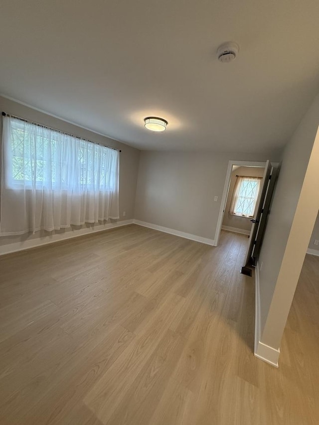 5301 S Mcvicker Ave, Chicago, IL 60638 - empty room featuring baseboards, light wood-type flooring, and a smoke detector