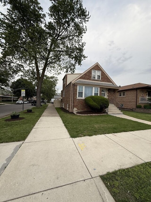 5301 S Mcvicker Ave, Chicago, IL 60638 - view of side of property featuring brick siding and a lawn