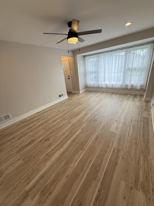 5301 S Mcvicker Ave, Chicago, IL 60638 - unfurnished room featuring ceiling fan, light wood-style floors, and baseboards