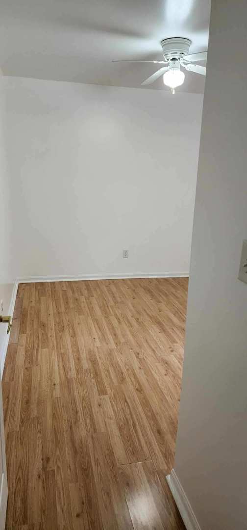 2820 S Brooks Island Rd, Oregon, IL 61061 - spare room featuring wood finished floors, ceiling fan, and baseboards