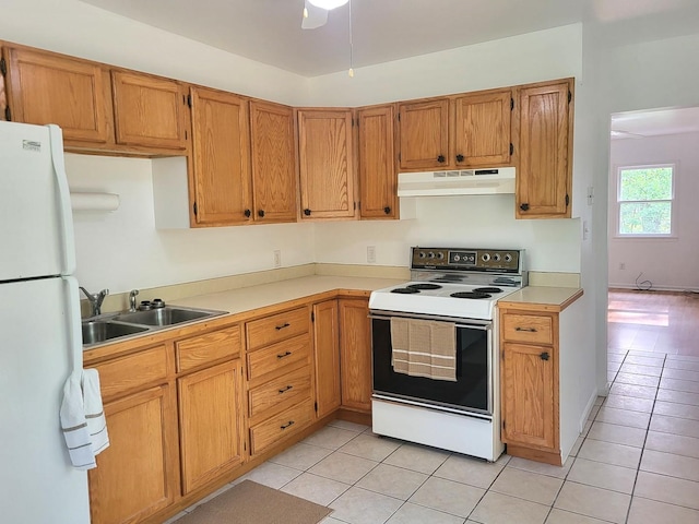 2820 S Brooks Island Rd, Oregon, IL 61061 - kitchen featuring white appliances, under cabinet range hood, a sink, and light tile patterned floors