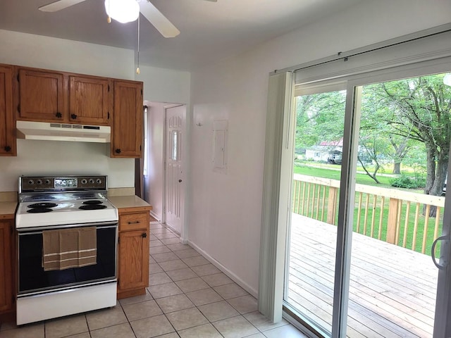 2820 S Brooks Island Rd, Oregon, IL 61061 - kitchen with under cabinet range hood, electric range, light countertops, light tile patterned floors, and a ceiling fan