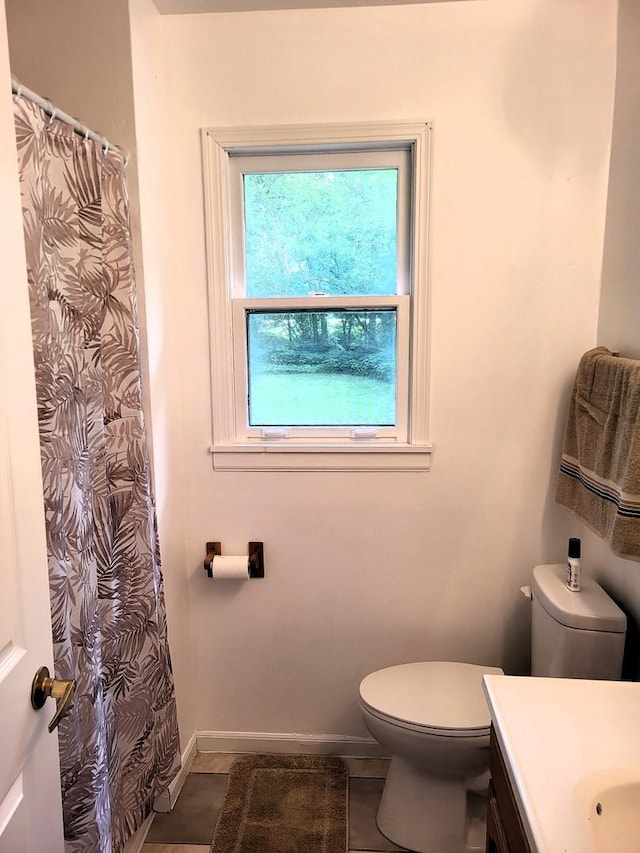 2820 S Brooks Island Rd, Oregon, IL 61061 - full bath with vanity, toilet, baseboards, tile patterned floors, and a shower with curtain