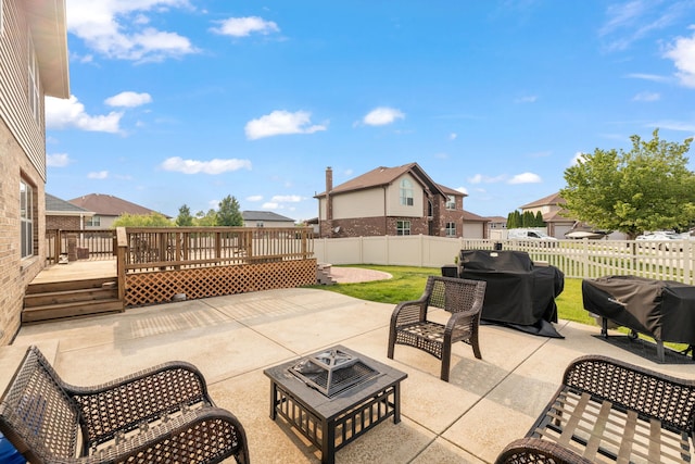 15826 Chippewa Ln, Manhattan, IL 60442 - fenced backyard featuring an outdoor fire pit, a deck, a patio, a residential view, and area for grilling