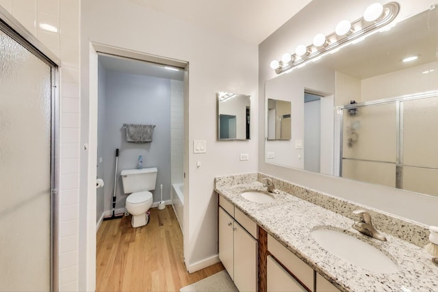 900 W Ainslie St Unit A, Chicago, IL 60640 - bathroom with an enclosed shower, wood finished floors, and double vanity