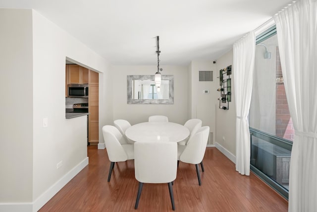440 N Mcclurg Ct Unit 301, Chicago, IL 60611 - dining area featuring wood finished floors and baseboards
