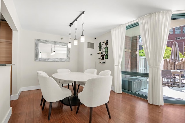 440 N Mcclurg Ct Unit 301, Chicago, IL 60611 - dining area featuring baseboards, hardwood / wood-style floors, and track lighting
