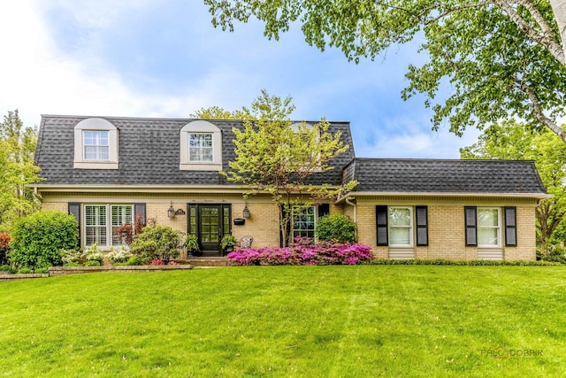 605 E Golf Rd, Libertyville, IL 60048 - view of front property featuring brick siding, mansard roof, a shingled roof, and a front lawn