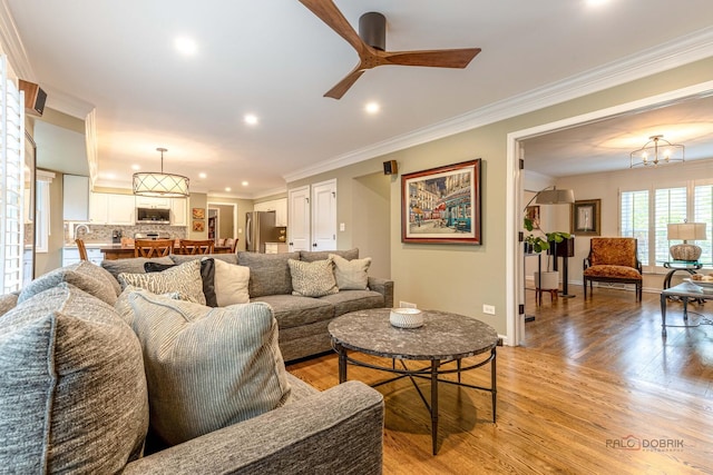 605 E Golf Rd, Libertyville, IL 60048 - living room featuring recessed lighting, light wood-style flooring, ornamental molding, ceiling fan, and a chandelier