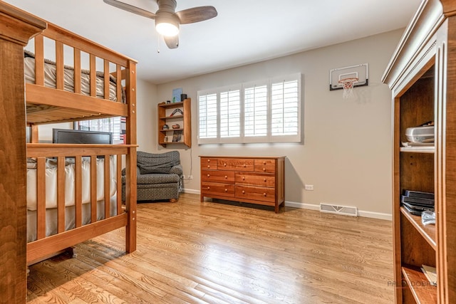 605 E Golf Rd, Libertyville, IL 60048 - bedroom featuring multiple windows, wood finished floors, baseboards, and a ceiling fan