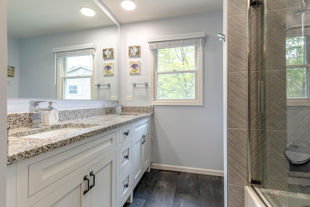 605 E Golf Rd, Libertyville, IL 60048 - bathroom featuring double vanity, wood finished floors, bath / shower combo with glass door, baseboards, and recessed lighting