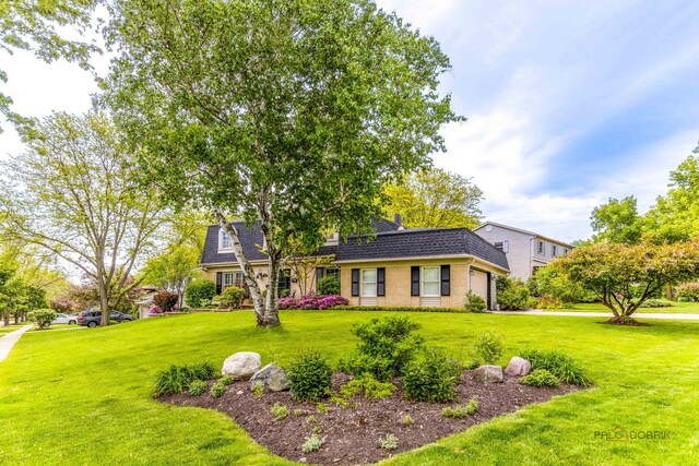 605 E Golf Rd, Libertyville, IL 60048 - view of front facade featuring a garage, a front yard, brick siding, mansard roof, and a shingled roof