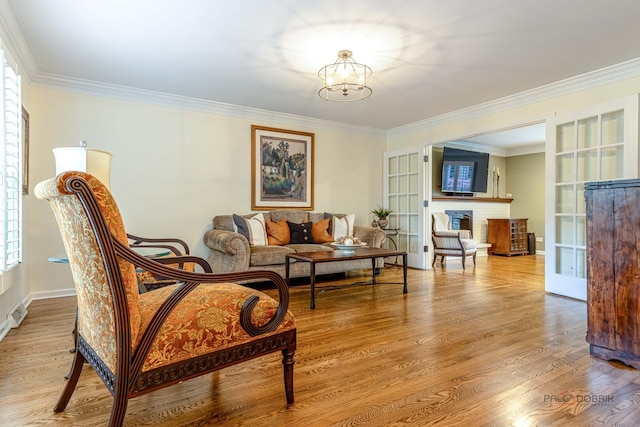 605 E Golf Rd, Libertyville, IL 60048 - living room featuring ornamental molding, wood finished floors, a chandelier, a fireplace, and baseboards