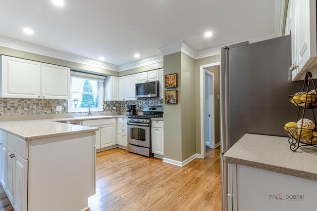 605 E Golf Rd, Libertyville, IL 60048 - kitchen with appliances with stainless steel finishes, light wood finished floors, ornamental molding, white cabinets, and backsplash