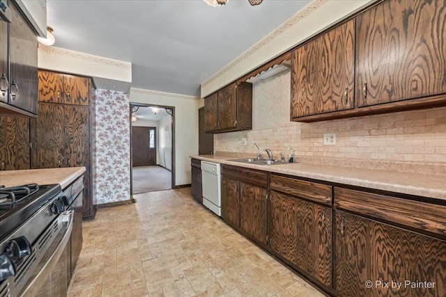 6704 Cypress Ct, Crystal Lake, IL 60012 - kitchen featuring a sink, baseboards, decorative backsplash, gas stove, and light countertops