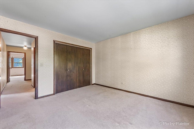 6704 Cypress Ct, Crystal Lake, IL 60012 - unfurnished bedroom with light carpet, a closet, baseboards, and wallpapered walls