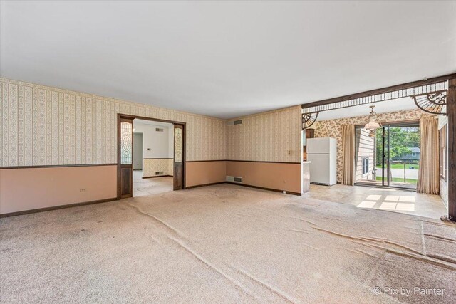 6704 Cypress Ct, Crystal Lake, IL 60012 - unfurnished living room with wallpapered walls, carpet flooring, and baseboards