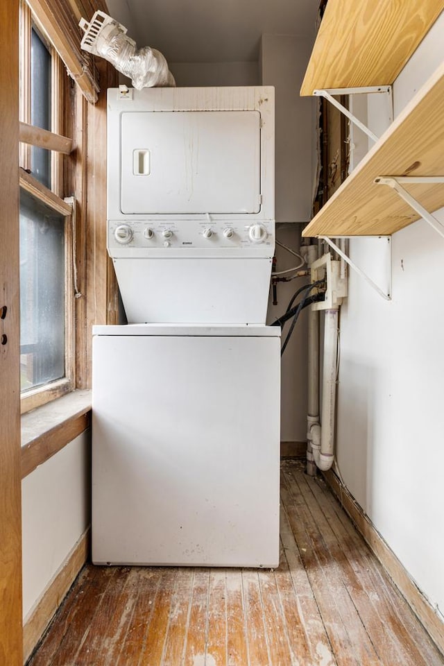 6801 S Crandon Ave Unit 1, Chicago, IL 60649 - laundry area featuring stacked washer / drying machine and hardwood / wood-style flooring