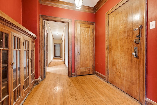 6801 S Crandon Ave Unit 1, Chicago, IL 60649 - hallway featuring crown molding, light wood-style floors, and baseboards