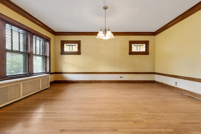 6801 S Crandon Ave Unit 1, Chicago, IL 60649 - spare room featuring radiator, a chandelier, ornamental molding, light wood finished floors, and baseboards