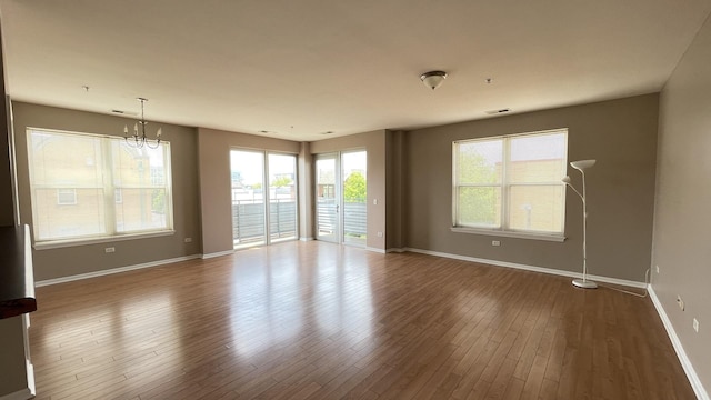 3522 S State St Unit 301, Chicago, IL 60609 - spare room with healthy amount of natural light, baseboards, a chandelier, and wood finished floors