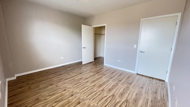 3522 S State St Unit 301, Chicago, IL 60609 - unfurnished bedroom with wood finished floors, baseboards, and a closet