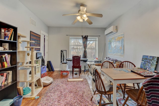 3342 S Aberdeen St, Chicago, IL 60608 - dining space featuring an AC wall unit, ceiling fan, and wood finished floors