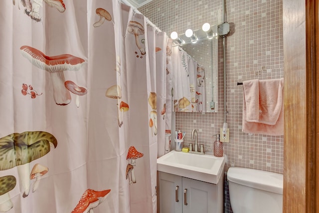3342 S Aberdeen St, Chicago, IL 60608 - full bath with tile walls, vanity, toilet, decorative backsplash, and a shower with curtain