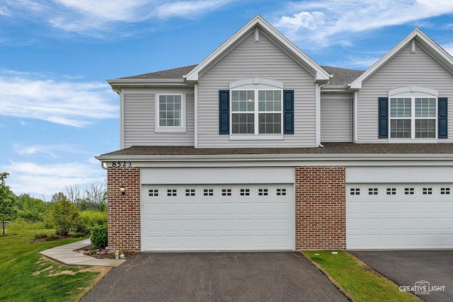 8523 Stillwater Rd, Wonder Lake, IL 60097 - traditional-style home with brick siding, asphalt driveway, an attached garage, and a shingled roof