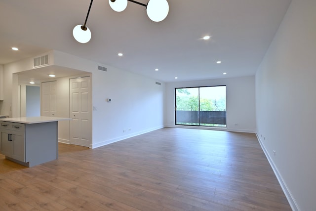 700 Wellington Ave Unit 315, Elk Grove Village, IL 60007 - unfurnished living room with light wood-style floors, baseboards, and recessed lighting
