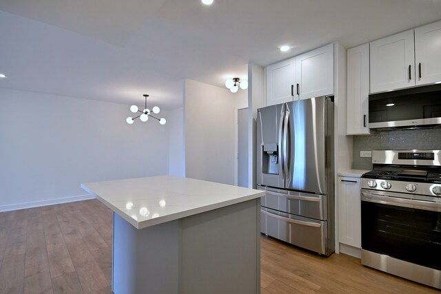 700 Wellington Ave Unit 315, Elk Grove Village, IL 60007 - kitchen with stainless steel appliances, light countertops, light wood finished floors, decorative backsplash, and recessed lighting