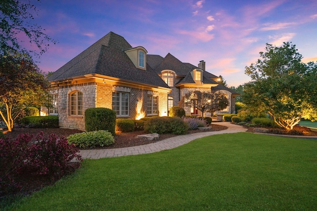 24355 S Arranmore Way, Frankfort, IL 60423 - french provincial home featuring stone siding, a front yard, and a chimney