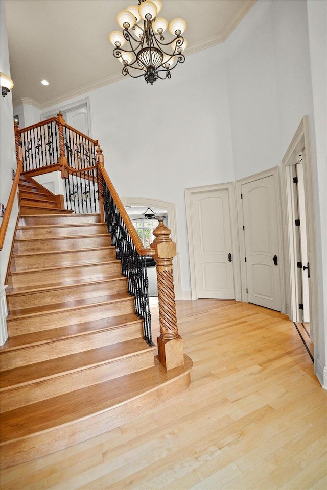 24355 S Arranmore Way, Frankfort, IL 60423 - staircase with a chandelier, crown molding, a towering ceiling, wood finished floors, and baseboards