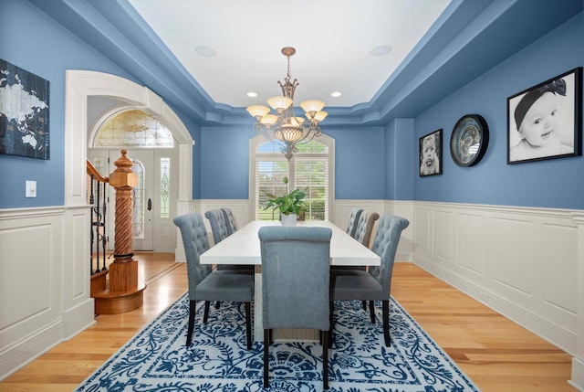 24355 S Arranmore Way, Frankfort, IL 60423 - dining room featuring a chandelier, a decorative wall, a wainscoted wall, wood finished floors, and a raised ceiling
