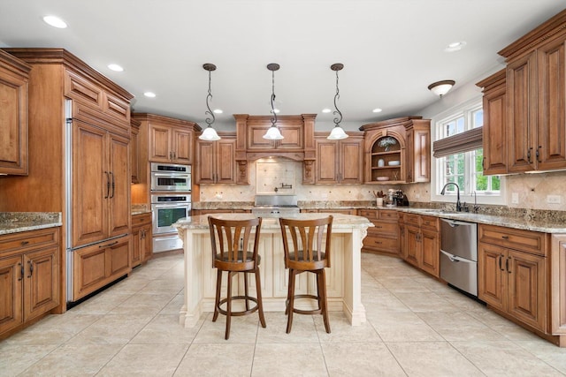 24355 S Arranmore Way, Frankfort, IL 60423 - kitchen featuring stainless steel appliances, brown cabinets, a warming drawer, tasteful backsplash, and a kitchen island